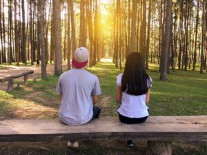 boy girl looking into forrest